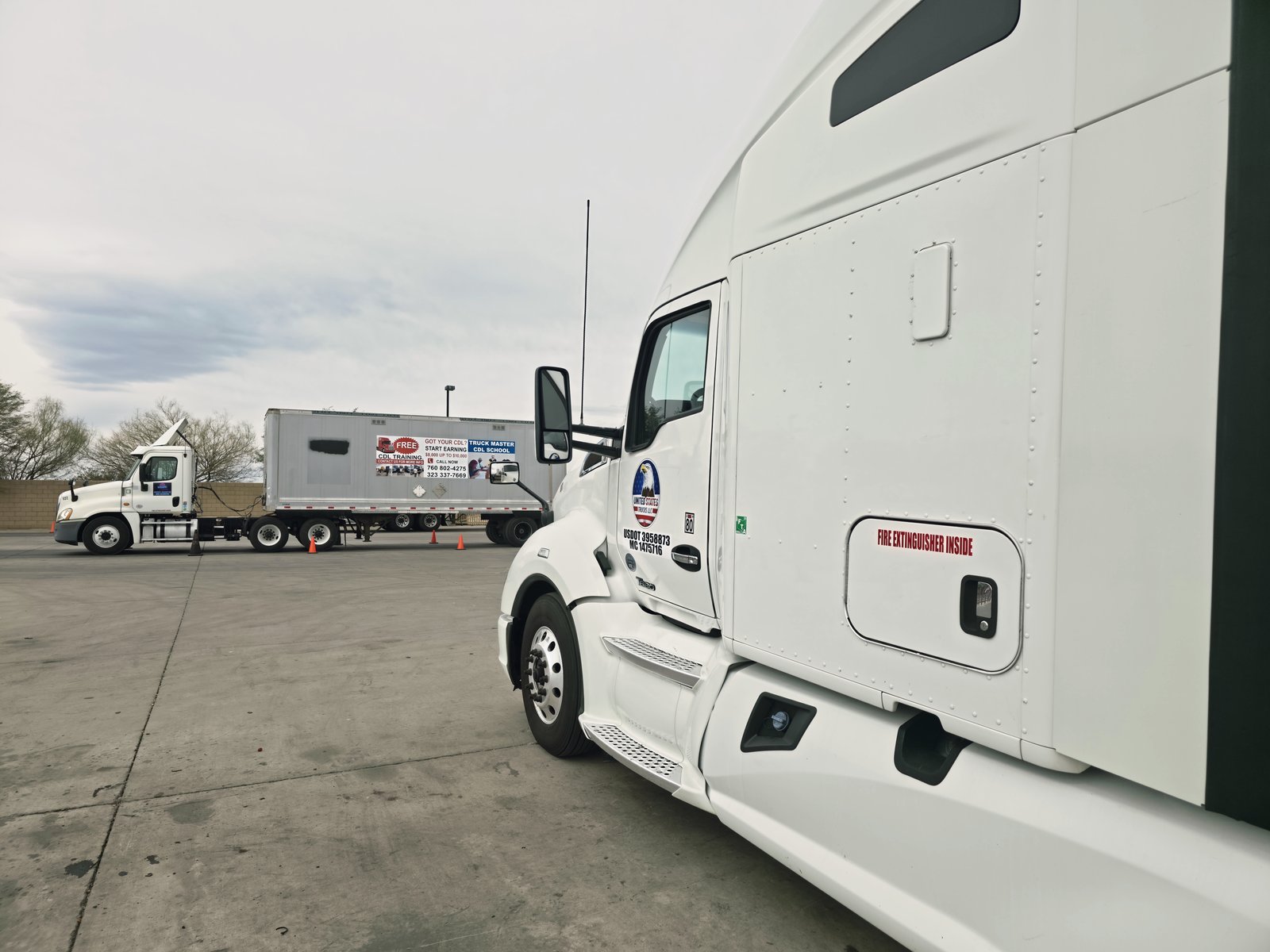 Truck Master CDL School truck with United States Trucks sister fleet in the yard